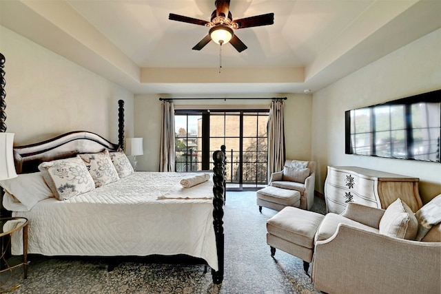 bedroom featuring a raised ceiling, carpet floors, access to outside, and ceiling fan