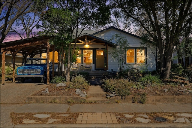 view of front of property featuring a porch and a carport