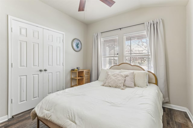 bedroom with a closet, ceiling fan, vaulted ceiling, and dark wood-type flooring