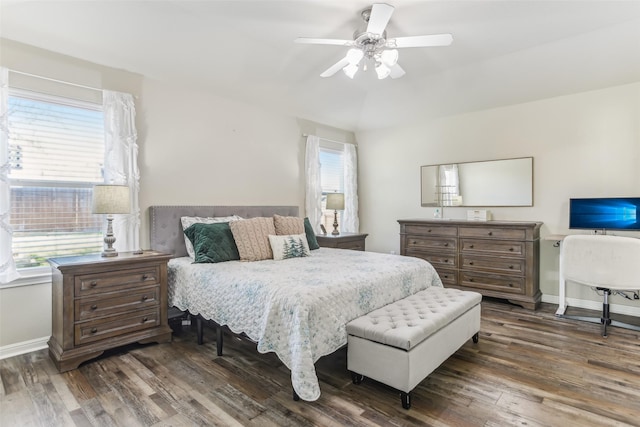 bedroom with dark hardwood / wood-style flooring and ceiling fan