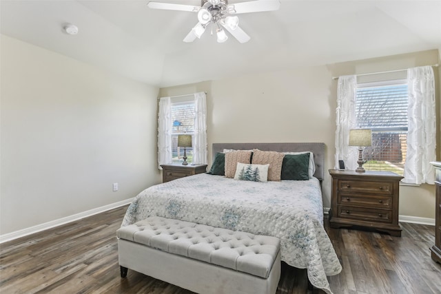 bedroom with ceiling fan, dark hardwood / wood-style flooring, and multiple windows