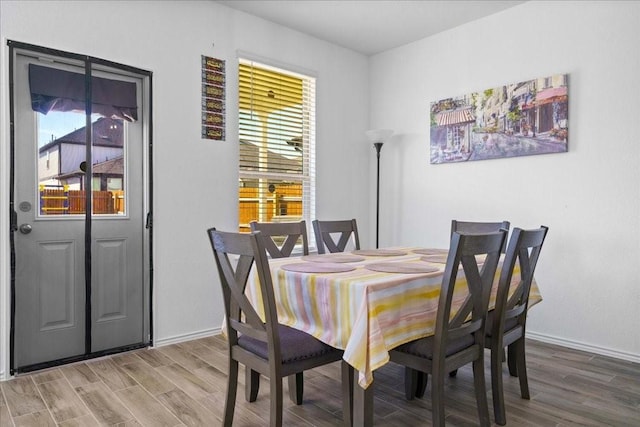 dining area featuring hardwood / wood-style floors and plenty of natural light