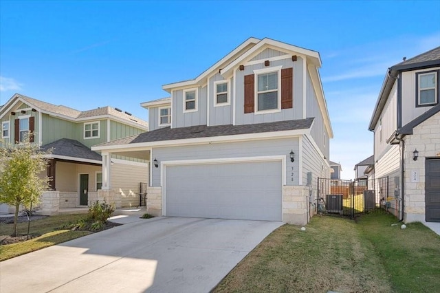 view of front of property with a garage, cooling unit, and a front lawn