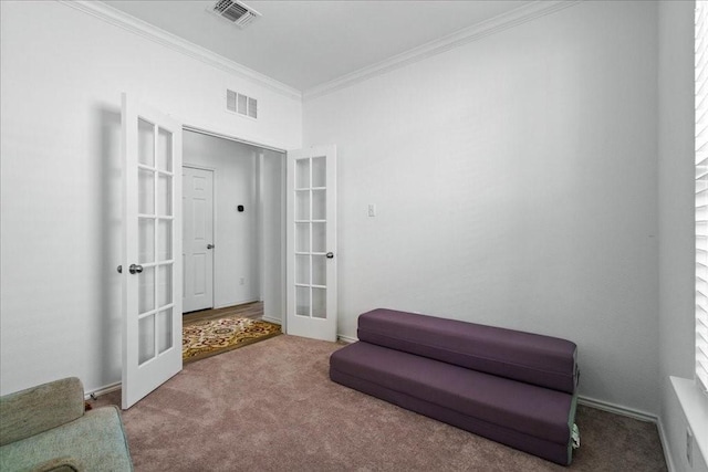 sitting room with crown molding, french doors, and carpet floors