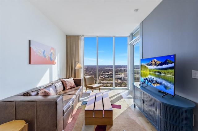 living room featuring expansive windows, a healthy amount of sunlight, and light hardwood / wood-style floors