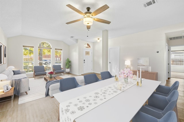 dining area with lofted ceiling, ceiling fan, and light wood-type flooring