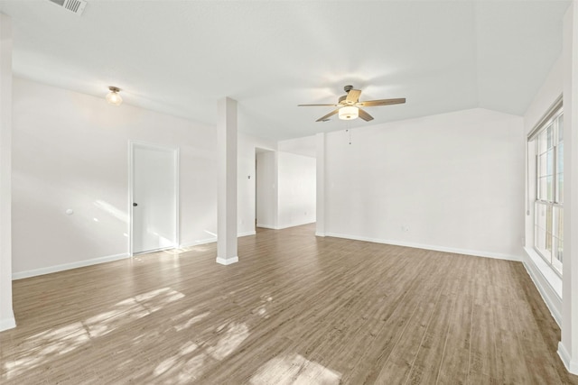 unfurnished living room featuring vaulted ceiling, hardwood / wood-style flooring, and ceiling fan