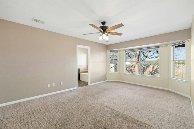 carpeted empty room featuring ceiling fan