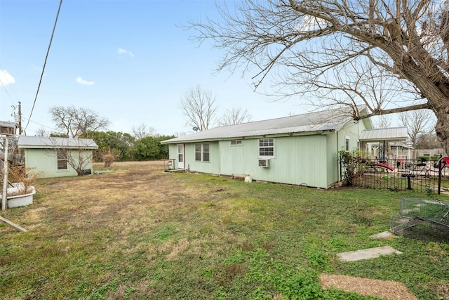 rear view of property featuring a yard and cooling unit