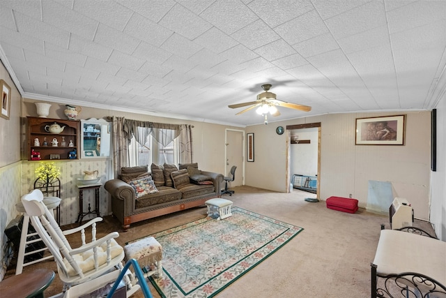 living room with ceiling fan, crown molding, and carpet floors