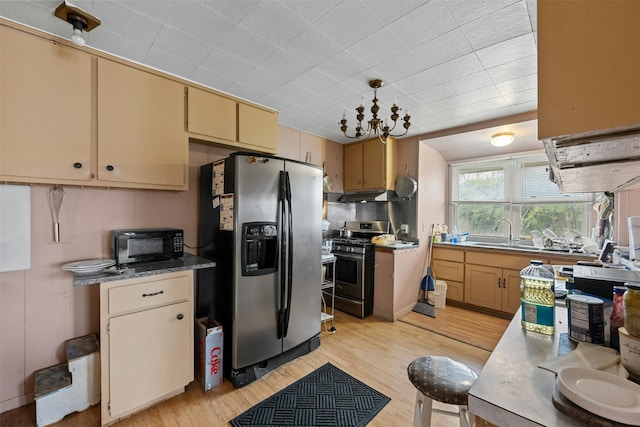 kitchen with sink, light hardwood / wood-style flooring, pendant lighting, a notable chandelier, and appliances with stainless steel finishes