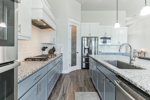 kitchen with sink, white cabinetry, backsplash, and appliances with stainless steel finishes