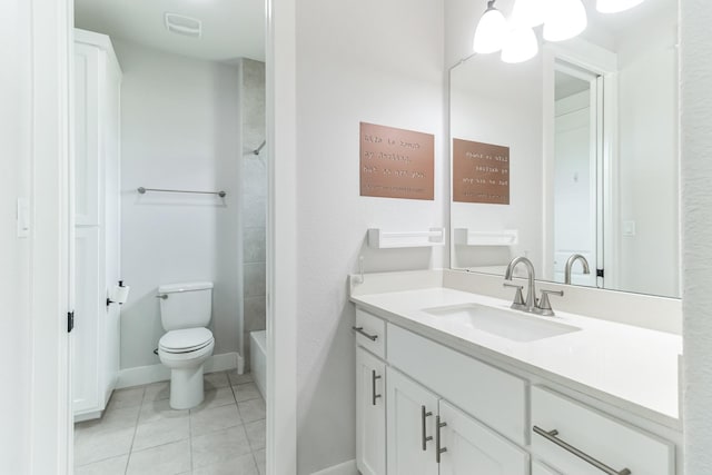 bathroom with toilet, vanity, and tile patterned floors