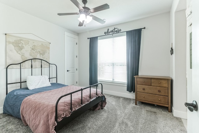 carpeted bedroom featuring multiple windows and ceiling fan