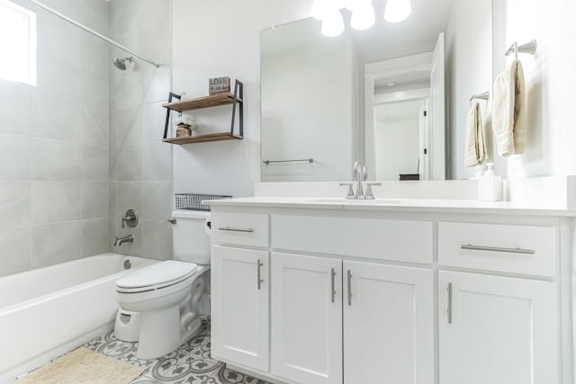 full bathroom featuring toilet, vanity, and tiled shower / bath combo