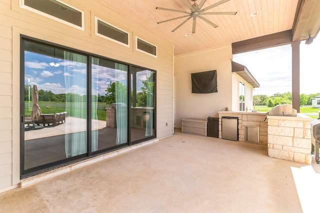 view of patio with ceiling fan and exterior kitchen