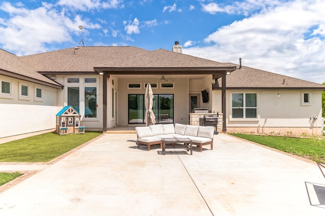 rear view of property featuring an outdoor hangout area, a patio, an outdoor kitchen, ceiling fan, and a yard