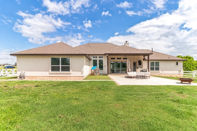 rear view of house featuring a patio area and a yard