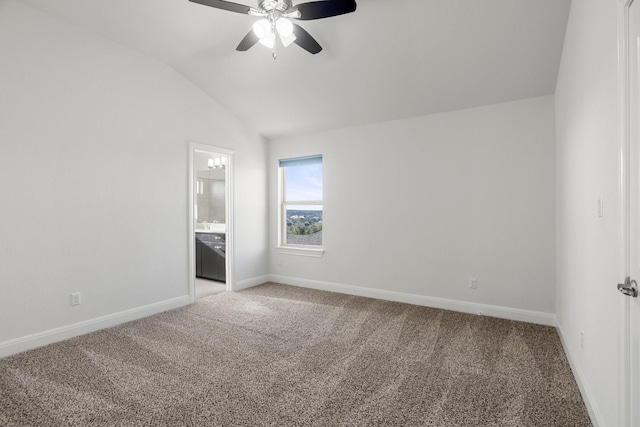 unfurnished bedroom with lofted ceiling, ceiling fan, carpet, and connected bathroom