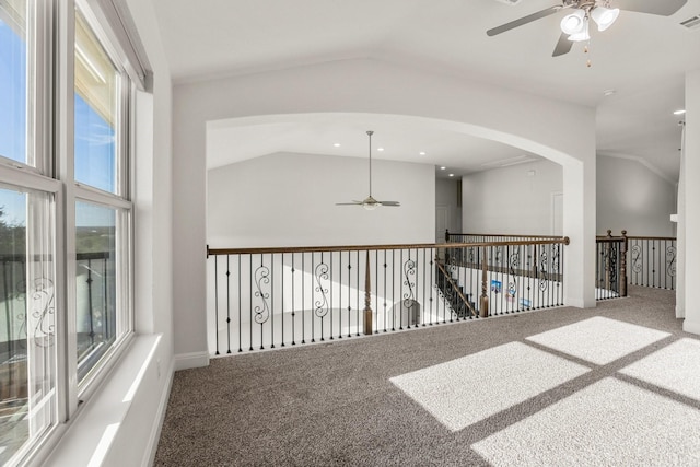 corridor with lofted ceiling and carpet floors