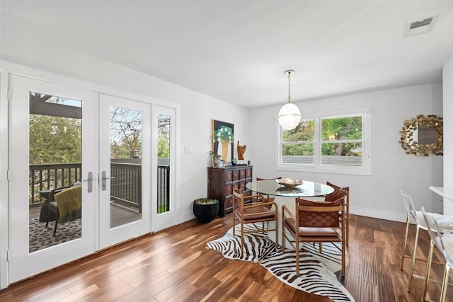 dining room with french doors, dark hardwood / wood-style flooring, and a healthy amount of sunlight