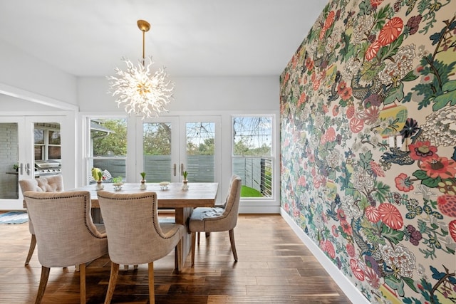 dining room with french doors, an inviting chandelier, and hardwood / wood-style flooring