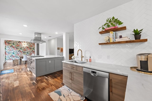 kitchen with light stone counters, dark hardwood / wood-style floors, stainless steel appliances, island exhaust hood, and sink