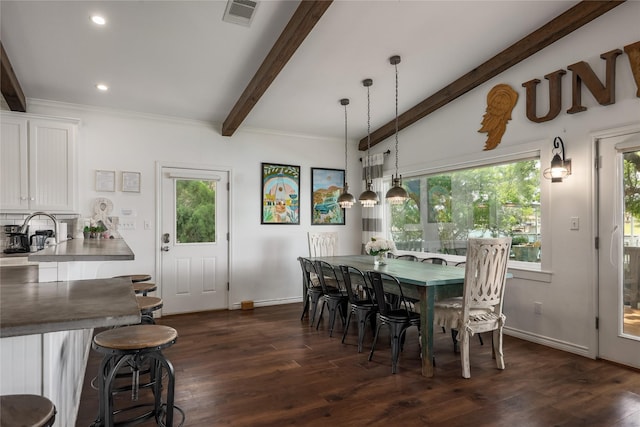 dining space with dark hardwood / wood-style flooring and vaulted ceiling with beams