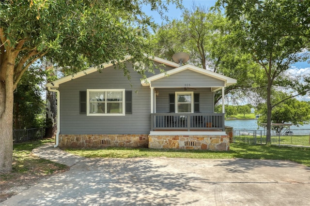 view of front of property with a water view and covered porch