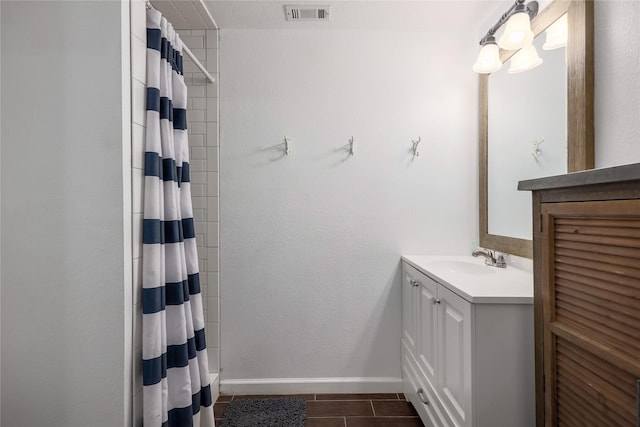 bathroom featuring walk in shower and vanity