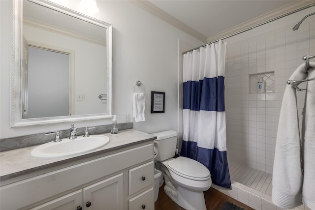 bathroom featuring toilet, a shower with shower curtain, crown molding, wood-type flooring, and vanity