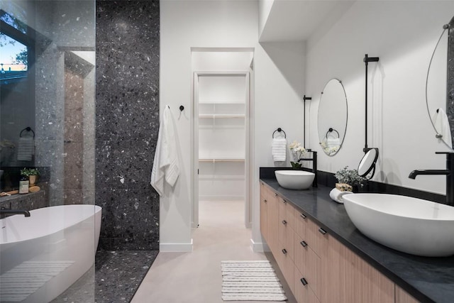 2512 Ridgeview St, Austin, TX 78704 - bathroom with a freestanding tub, double vanity, a walk in closet, and a tile shower