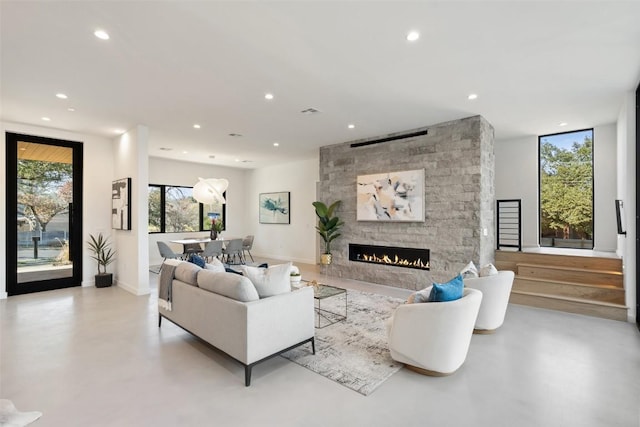 2512 Ridgeview St, Austin, TX 78704 - living area featuring concrete flooring, recessed lighting, and a stone fireplace