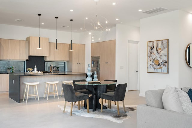 dining area with sink and a chandelier