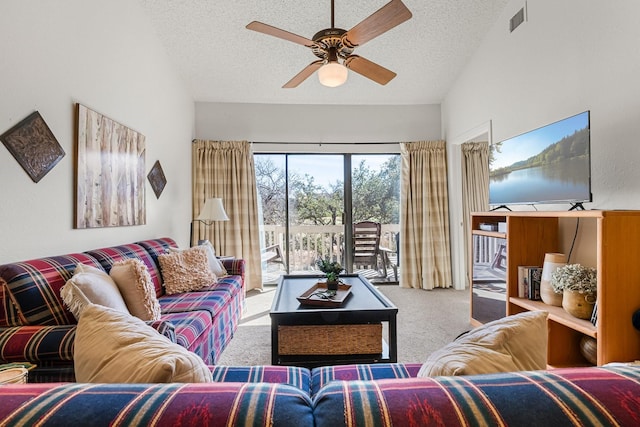 carpeted living room featuring a textured ceiling, ceiling fan, and lofted ceiling