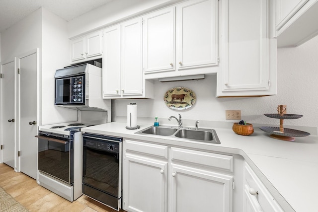 kitchen featuring electric range oven, white cabinets, black dishwasher, and sink