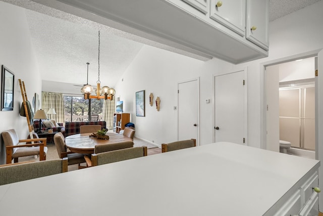 interior space featuring a textured ceiling, an inviting chandelier, and vaulted ceiling