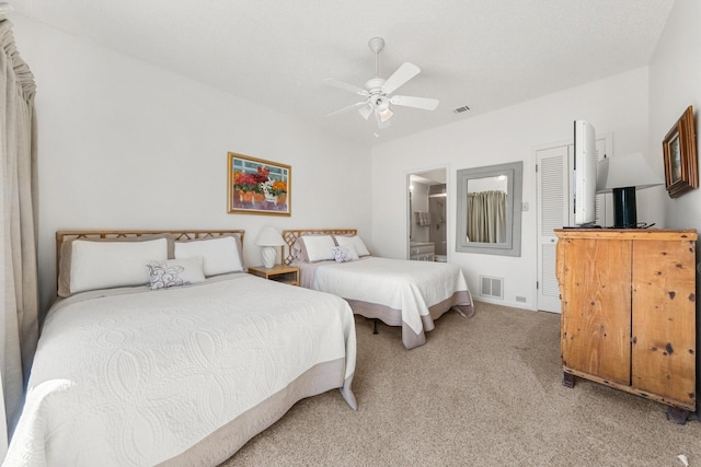 carpeted bedroom with ceiling fan and ensuite bathroom