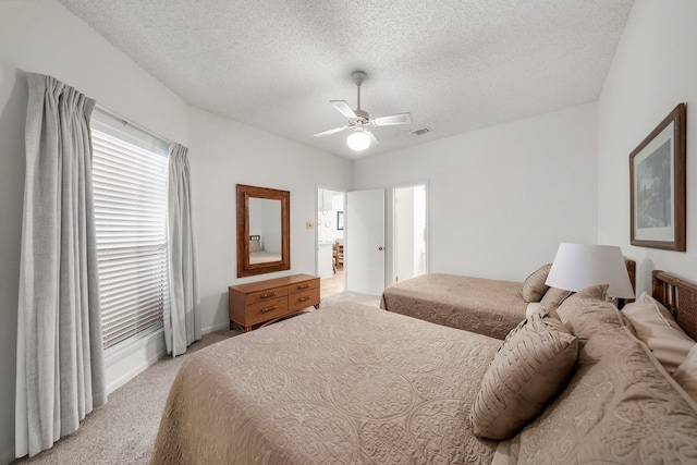 carpeted bedroom with a textured ceiling and ceiling fan