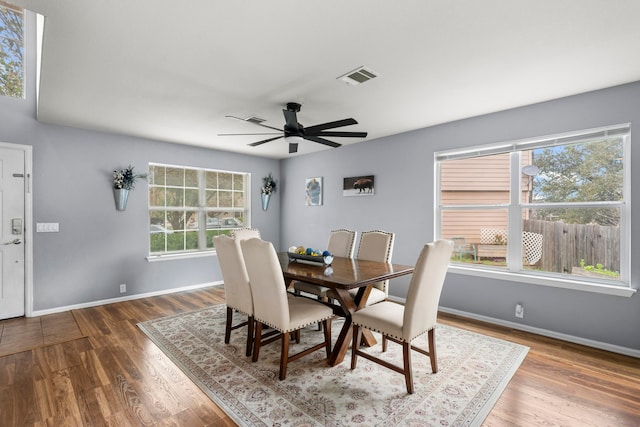 dining space with ceiling fan and hardwood / wood-style floors