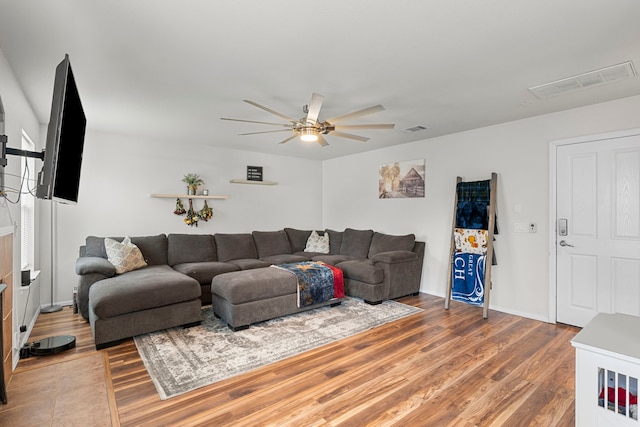 living room featuring ceiling fan and wood-type flooring