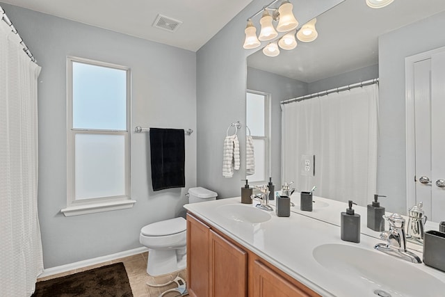 bathroom featuring toilet, vanity, tile patterned floors, and an inviting chandelier