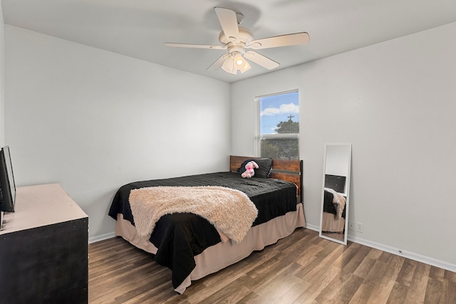 bedroom with ceiling fan and dark hardwood / wood-style flooring