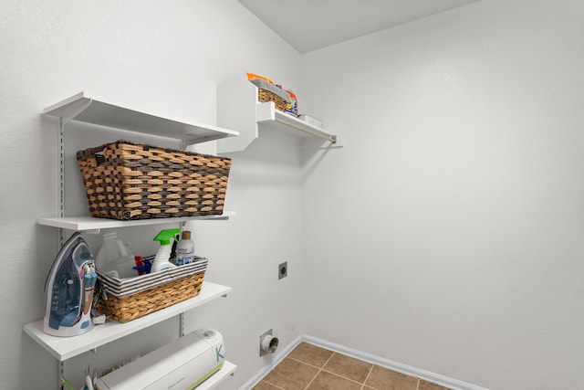 laundry area with light tile patterned floors and hookup for an electric dryer