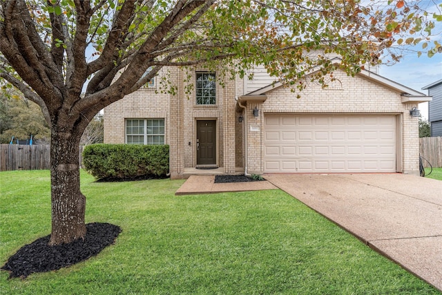 view of front of home featuring a garage and a front yard