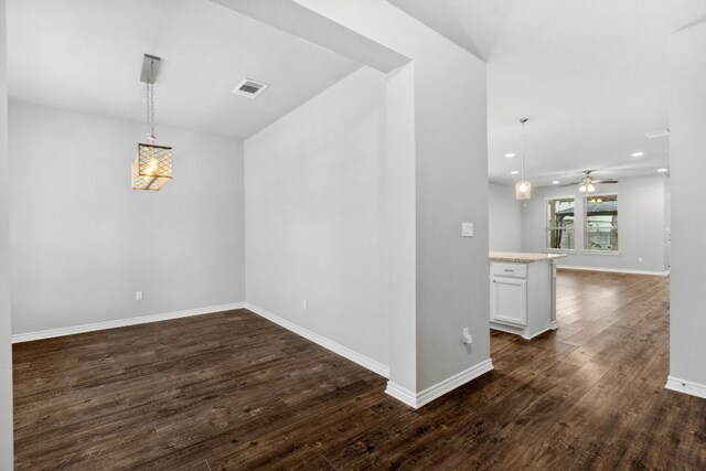 spare room with dark wood-type flooring and ceiling fan