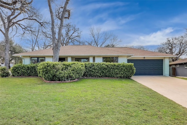 ranch-style house featuring a garage and a front lawn