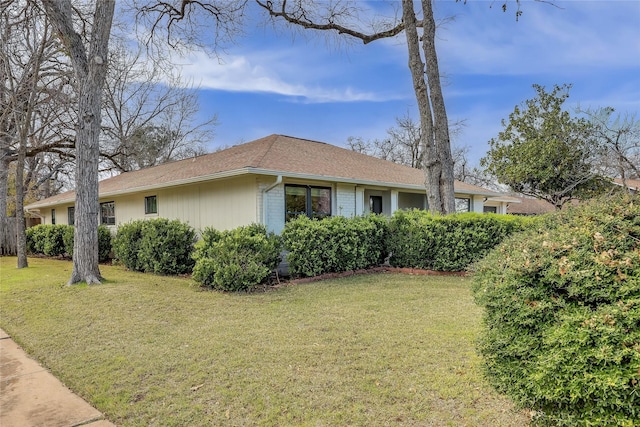 view of side of property with a lawn