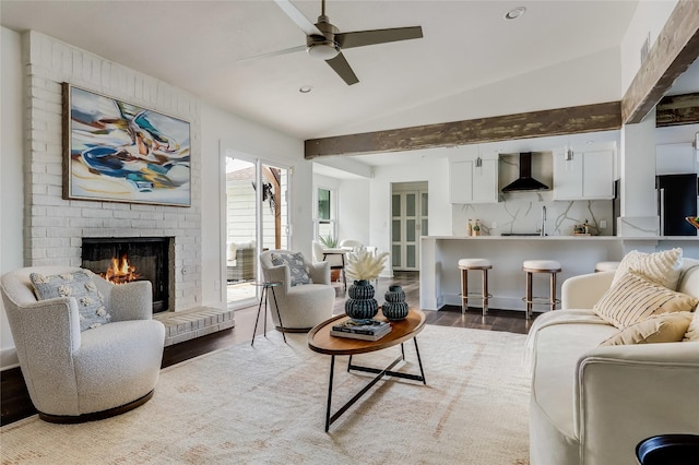 living room featuring a fireplace, ceiling fan, vaulted ceiling, and dark hardwood / wood-style floors