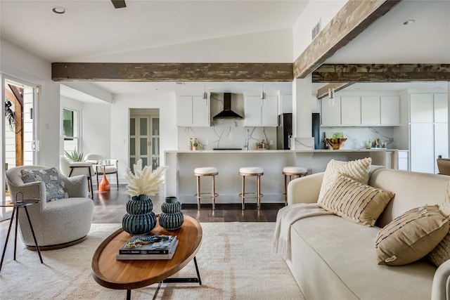 living room with dark wood-type flooring and vaulted ceiling with beams